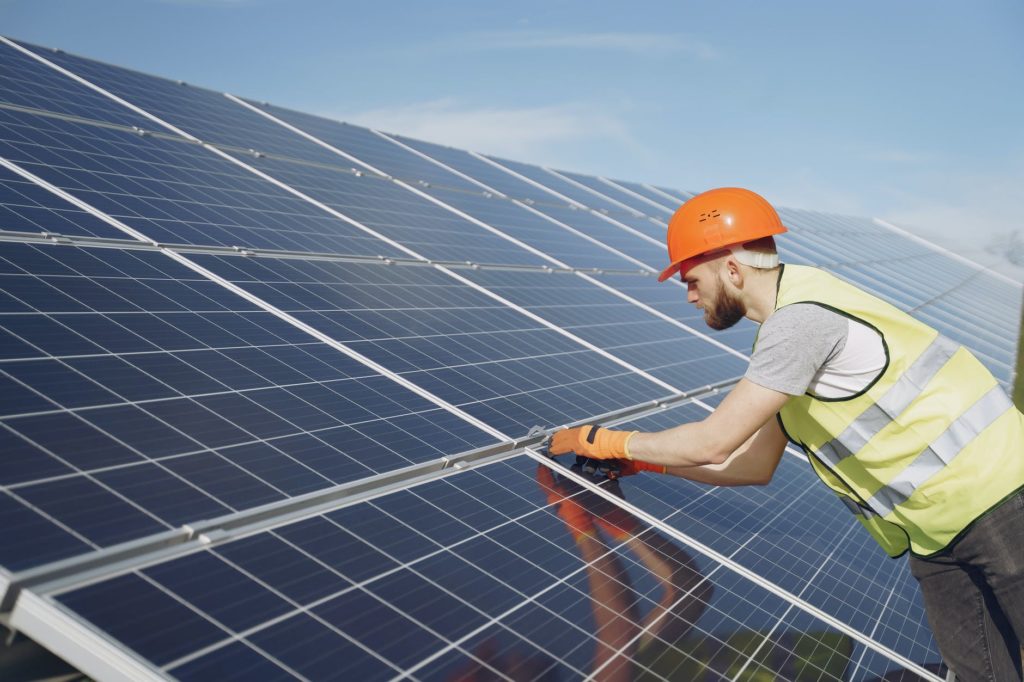 young engineer checking maintenance of solar panels